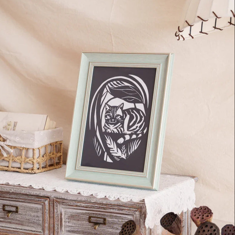 Picked this garden hide-and-seek photo of my cat for the paper-cut artwork, and now it's displayed at home