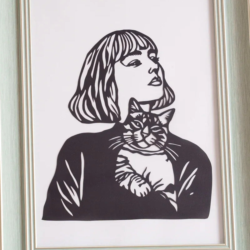 paper cut art featuring a lady with her cat in details 