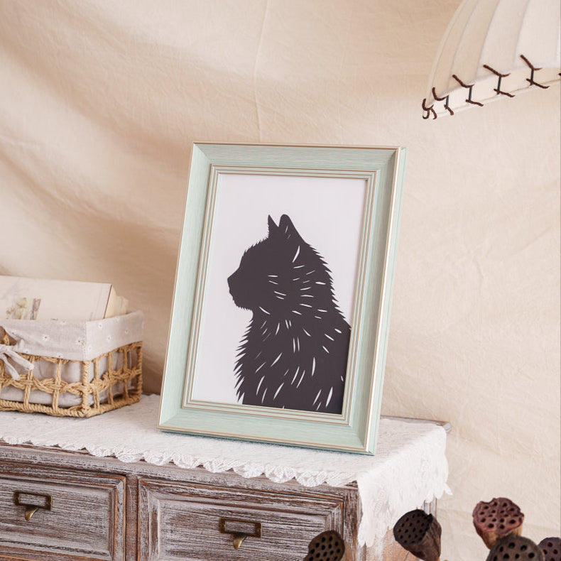 A framed, custom silhouette artwork of a beloved cat serving as a touching memorial piece and unique home decoration