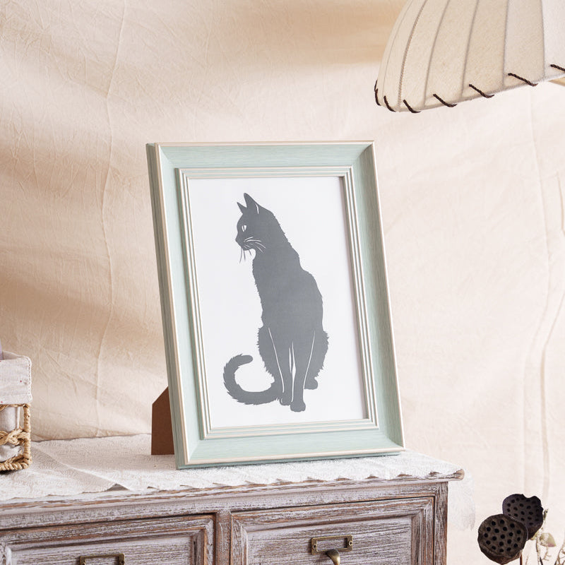 Framed cat paper cut memorial displayed at home as a pet keepsake.