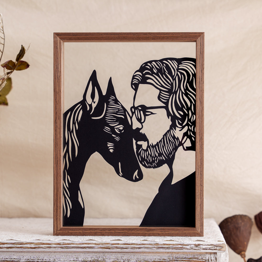 A custom memorial papercut capturing the heartfelt moment of a dog and its owner touching heads.