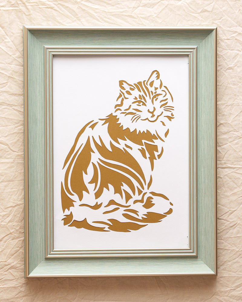 A delicate white paper-cut artwork featuring the distinctive silhouette of a Lionhead cat against a pure white background